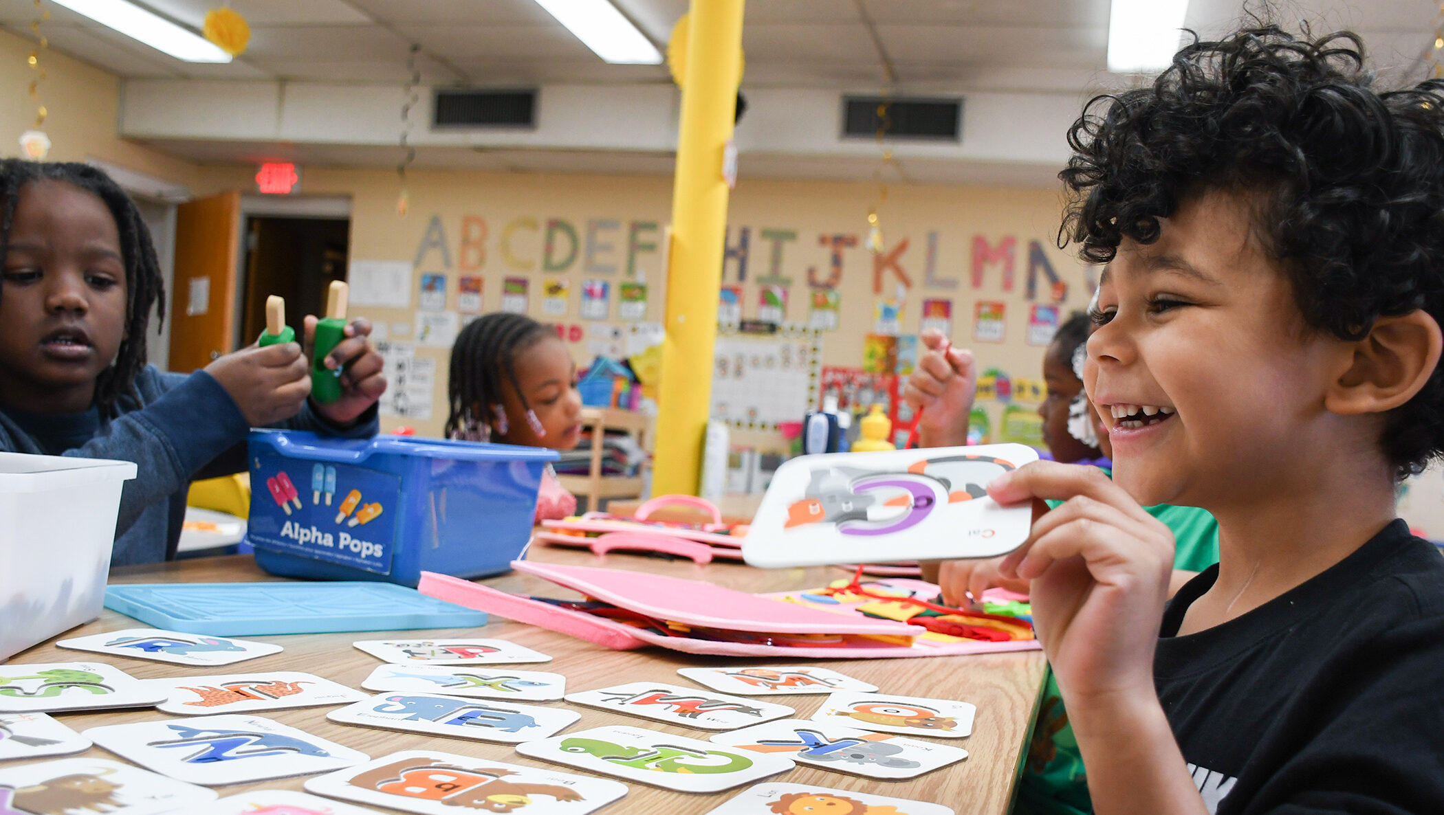 African American and mixed race children learning in a classroom.